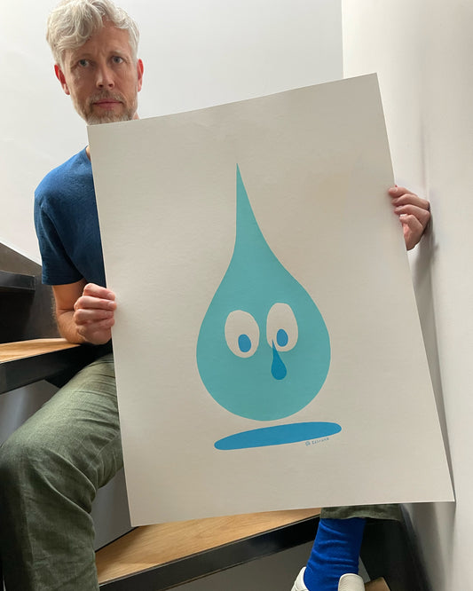 Ze holding the Crying Tear Drop limited-edition screen print by ZeTrunk with baby blue tear-shaped character and crying eyes